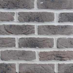 A picture of grey/brown brick slips with spotting. The product is called Crowborough Taupe